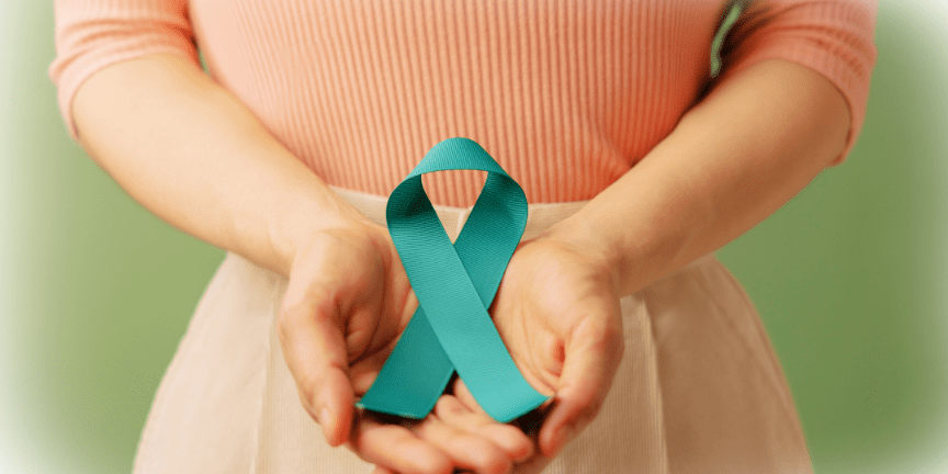 cervical cancer ribbon held in hands in front of waist